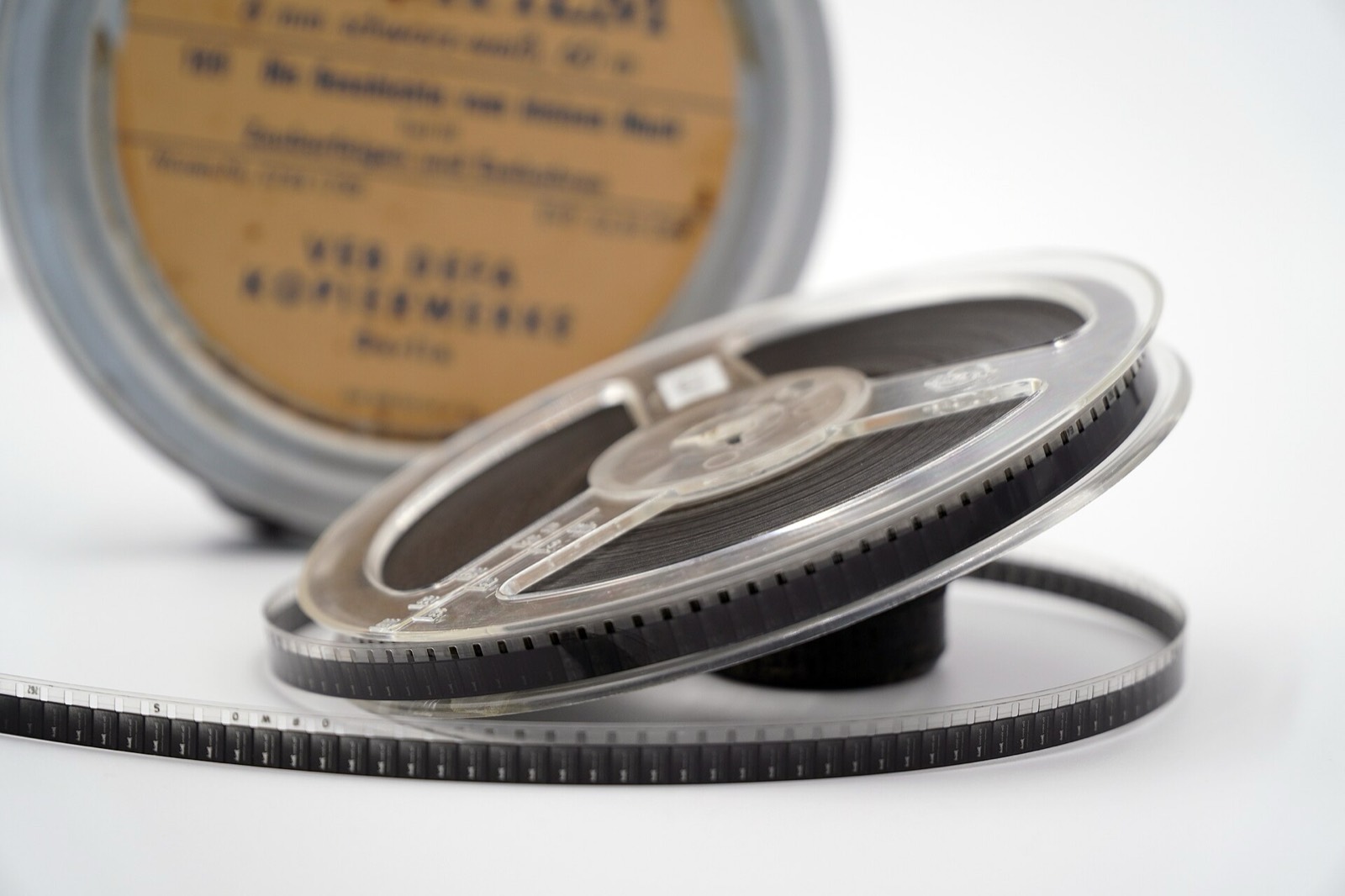 An 8 mm film reel resting against its canister